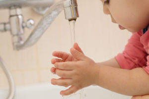 Little baby washing her hands
