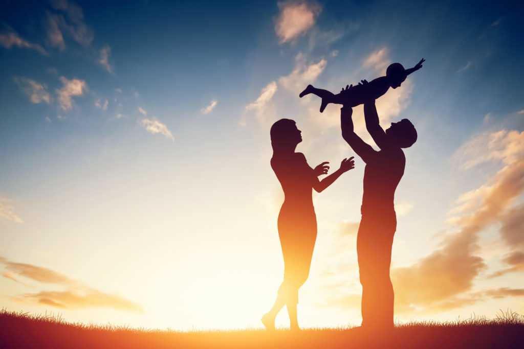 Happy family together, parents with their little child at sunset. -  Perspectives